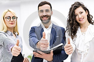 Close up of three workers in office.