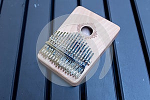 Close up of a thumb piano or kalimba on a wooden table