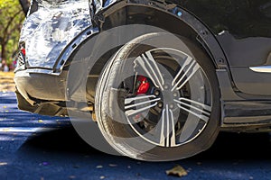 Close up tire after back black car damaged and broken by accident on road