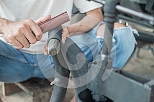 Close up of a tire repairer`s hand rubbing a leaky inner tube