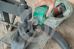 Close up of tire repairman`s hand when pouring fuel on a traditional press photo