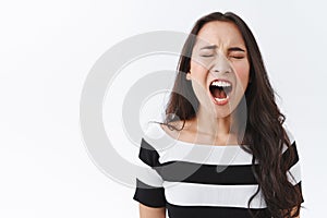 Close-up tired and unamused cute asian woman feeling bored during uninteresting date, yawning with opened mouth, close