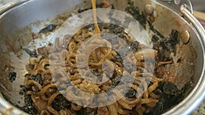 Close up to chopsticks pick up jajangmyeon traditional noodle in korean style