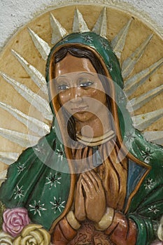 Close up to a figurine of the Virgin of Guadalupe