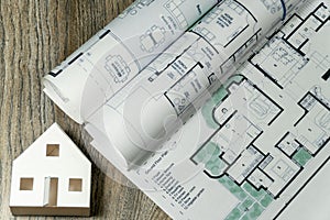 Close up to floor plans and carton white house. Architect drawings, expensive renovation, building construction cost