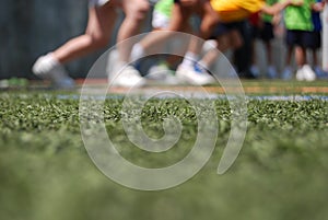 Close up to tennis shoes, kids running on grass photo