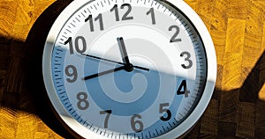 Close up to a wall clock, with running time pointer.