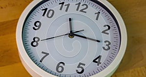 Close up to a wall clock, with running time pointer.