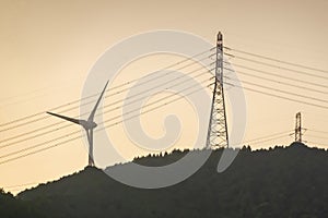 A close up to a wind turbine Windstream with some electricity towers