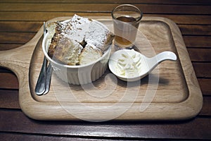 Close up toast in a cup with icing sugar powdered on top, honey in a mug shot, put on wooden plate,wooden table,morning breakfast