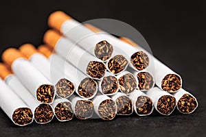 Close-up of tobacco cigarettes on a black background