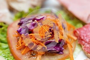 Close-up of tomato, carrot and lettuce salad