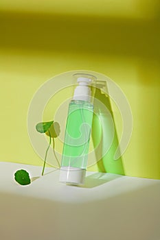 Close-up of a toner bottle containing light green liquid with pennywort extract. The concept of homemade cosmetics from natural