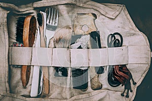 Close-up of a tool bag filled with various hair tools and utensils