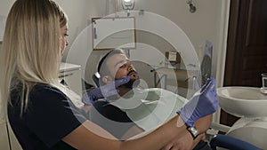 Close-up A tooth badge in the hands of a dentist. Stomatological services