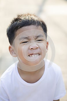 Close up tooth and kidding face of asian children standing outdoor