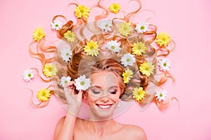 Close up top above high angle view photo beautiful she her amazing lady lying down among flowers long curly wavy hair