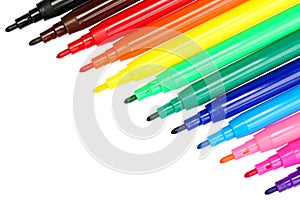Close up, top down of a set of multicolored felt tip pens, left open, isolated on white