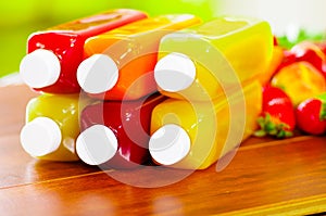 Close up top of juice bottles lying down stacked, beautiful colors and healthy concept