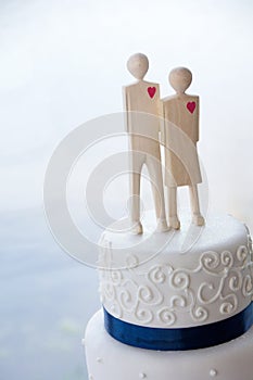 Detail of White Wedding Cake With Wooden Toppers photo