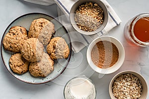 Close up top view on crunchy oatmeal chip cookies fresh baked biscuits with chocolate and cocoa in a plate on the table and