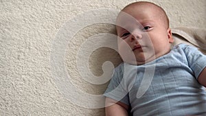 Close-up Top View Cute Kid 2 Month Newborn Boy Looking At Camera After Bath Shower On White Soft Bed. Baby Child Waking