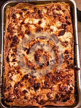 Close up and top view of a glorious home made lasagna, freshly baked