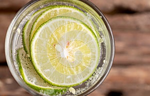 Close up top view green lime sliced in the soda water