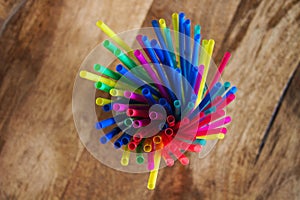Close up top view of a group of new colored plastic straws.