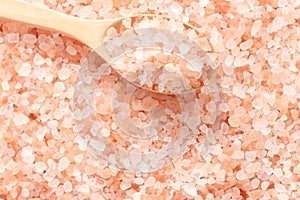 Close up top view of himalayan pink salt in wooden spoon