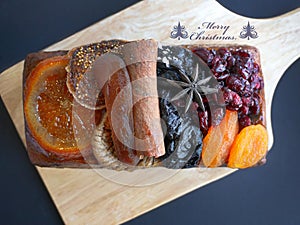 Close-up top view loaf of fruitcakes St-Germain elderflower liqueur seasons cake with Merry Christmas