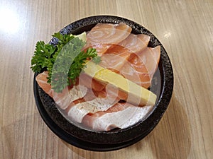 Close-up, Top view of salmon don, sliced salmons and Sweet egg on top of Japanese rice in black dish photo