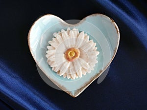 close-up top view of Sam Pan Nee Thai Traditional Dessert handcraft royal famous thai snack in pastel blue heart shape plate with