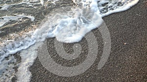 Close Up top view sea beach sea waves breaking on sandy coastline