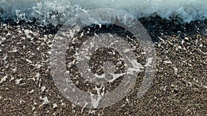 Close Up top view sea beach sea waves breaking on sandy coastline. Beautiful Turkish nature. Close-up shot of calming