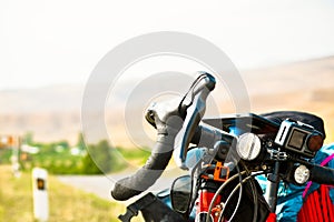 Close up touring bicycle stand on scenic gravel road in nature countryside. Fully loaded touring machine with copy space