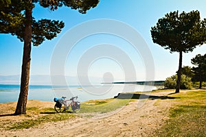 Close up touring bicycle stand on scenic nature countryside by sevan lake. Fully loaded touring machine with copy space background