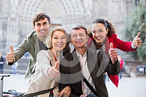 Close up of tourists posing on city street