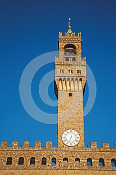 Close-up of the tower with clock from the Palazzo Vecchio to the sunset in Florence.