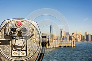 Close up of tower viewer binoculars with blurred New York City s