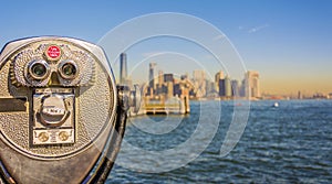 Close up of tower viewer binoculars with blurred New York City s