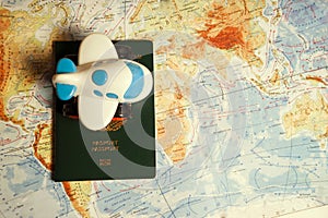 Close up the toy airplane and passport on the world map background. Travel and business concept.