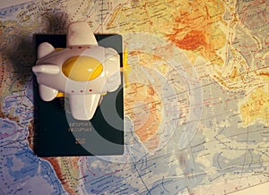 Close up the toy airplane and passport on the world map background. Travel and business concept.