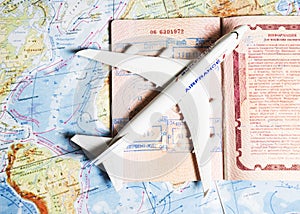 Close up the toy airplane and passport on the world map background. Travel and business concept