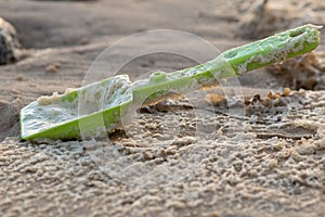 Close-up of toy plastic spade left on the beach