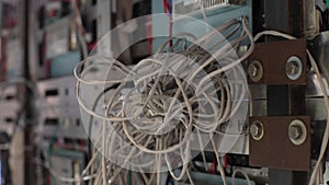 Close-up tracking shot of tangle of wires in server room. Close up push-out of many electrical and network wires at