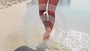 Close up tracking view woman barefoot walk steps on white sand in Nissi beach. CrystalcClear mediterranean waters. Cyprus relaxing