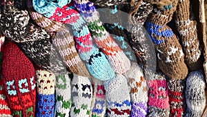 Close up traditional beautiful colorful hand-made socks for sale on display outside on babushkas stall