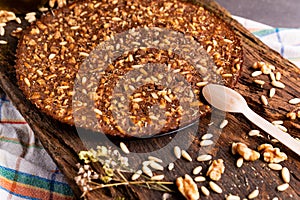 Close up of traditional castagnaccio cake, a classic italian gluten free autumn cake on wooden table made with chestnuts flour,