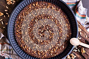 Close up of traditional castagnaccio cake, a classic italian gluten free autumn cake on wooden table made with chestnuts flour,